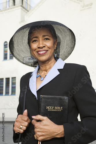 Photo: Senior African American woman in front of church Senior African American woman in front of church