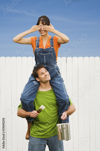Photo: Woman sitting on boyfriend's shoulders Woman sitting on boyfriend's shoulders