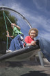 African American boys playing on swing