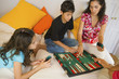 Hispanic family playing board game