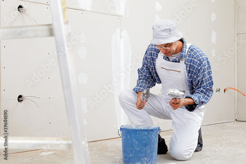 Photo: studwork: filling the joints of the plaster boards studwork: filling the joints of the plaster boards