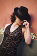 Hispanic woman wearing fedora hat