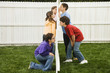 Mixed Race children looking at each other through fence