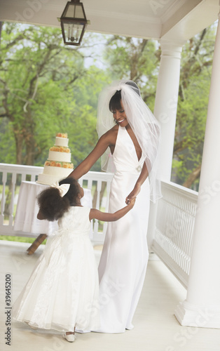 Photo: African American bride dancing with flower girl African American bride dancing with flower girl