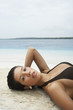 South American woman laying on beach