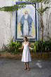Hispanic woman in front of Virgin Mary mosaic