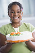 African American girl holding birthday cake