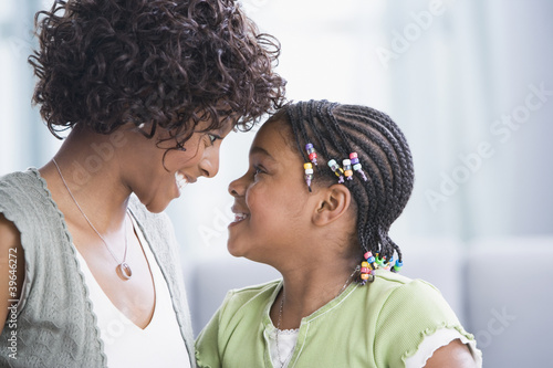Photo: African American mother and daughter smiling at each other African American mother and daughter smiling at each other