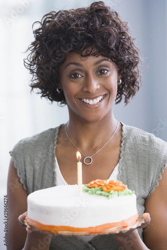 Photo: African American woman holding birthday cake African American woman holding birthday cake