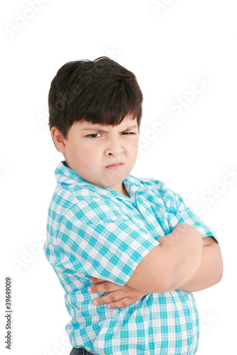 Photo: serious little boy with hands folded standing isolated on white serious little boy with hands folded standing isolated on white