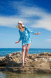 The young beautiful woman on seacoast