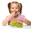 Photo: Little girl is eating grapes Little girl is eating grapes