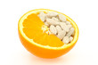 Close up of orange and pills isolated - vitamin concept