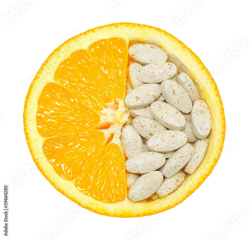 Photo: Close up of orange and pills isolated - vitamin concept Close up of orange and pills isolated - vitamin concept