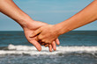Couple of hands on the sea view