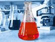 Laboratory glassware on blue background