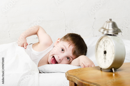 Photo: Boy awaken old alarm clock Boy awaken old alarm clock