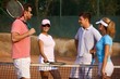 Young people on tennis court smiling