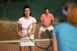 Young people playing mixed doubles Young people playing mixed doubles