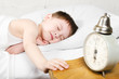 Boy 4 years sleeping bed old alarm clock brick wall