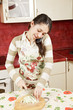 Brunette cutting cabbage on phone