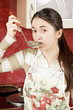 Woman tasting soup