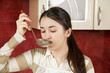Woman tasting soup closeup