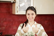Brunette gesturing both thumbs up