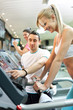 personal trainer instructing woman