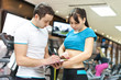 young girl with professional trainer  in gym