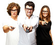 young friends changing channel over white background