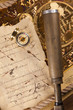 Vintage letter, compass and navigation equipment on map