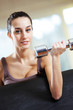 portrait of  young woman lifting free weights