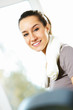 Beautiful sporty girl is smiling and resting in a gym.