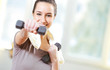 dumbbell in hand of working out young smiling female