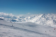 alpine skiers on long slopes in French Alps