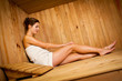 Young woman relaxing in a sauna