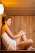 Young woman relaxing in a sauna