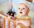 Beautiful funny baby girl with blue eyes looking up standing in Beautiful funny baby girl with blue eyes looking up standing in