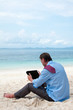 Business man working on the beach with tablet computer