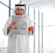 arabian business man in office drinking tea & reading news
