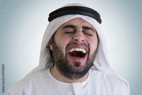 Photo: arabian man laughing - clipping path included for isolation arabian man laughing - clipping path included for isolation