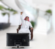 arabian man watching TV and reacting