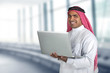 arabian businessman using laptop in his office