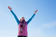 Teen girl staying with raised hands