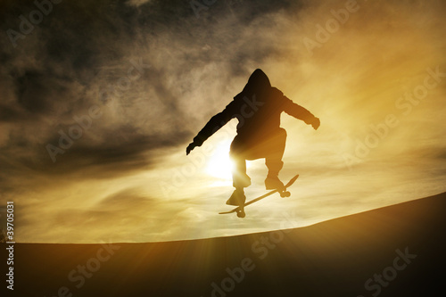 Photo: silhouette of skateboarder in sunset silhouette of skateboarder in sunset