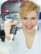 Customer shows car key in a garage after technical service