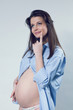 Beautiful thinking smiling pregnant white woman