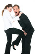 Beautiful woman kicking a businessman