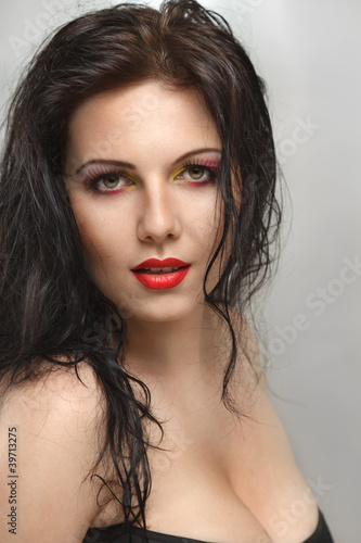 Photo: Young woman with curly hair Young woman with curly hair
